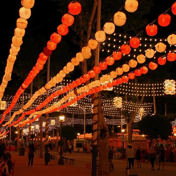 A street at night decorated with decorations for the April Fair