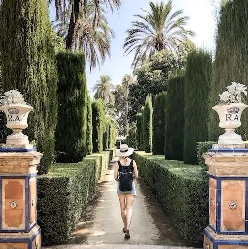 A girl walking through the María Luisa park