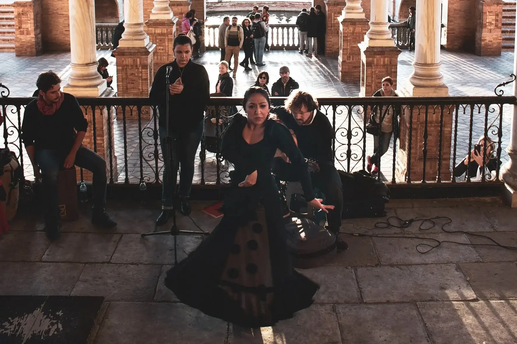 Woman dancing flamenco in the Plaza de España with the band behind her