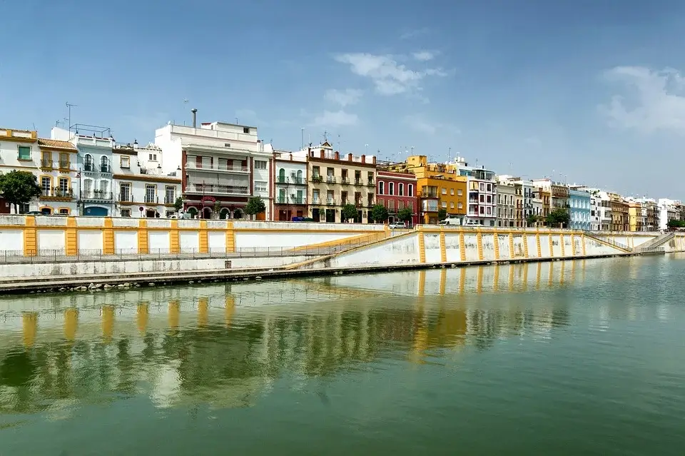 View of the colourful buildings of Triana next to the river